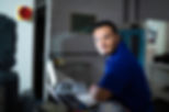 A portrait of a man with a disability at work looking at the camera