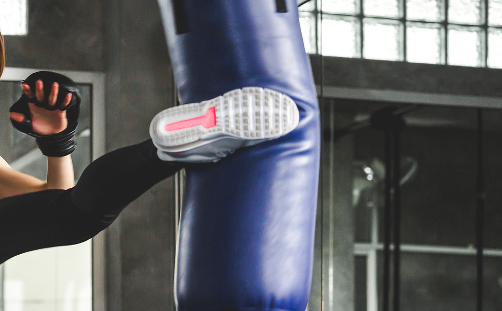 Woman Kicking Punching Bag
