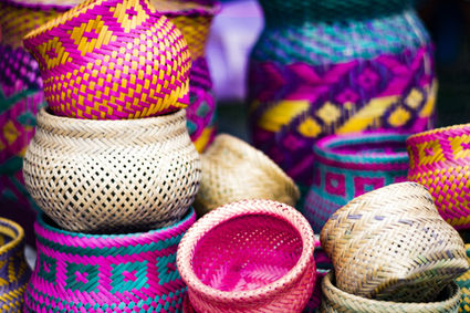Stacks of colorful handwoven baskets rest against each other