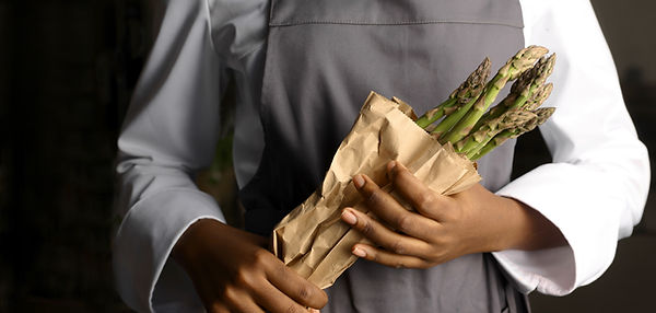 Chef sosteniendo espárragos