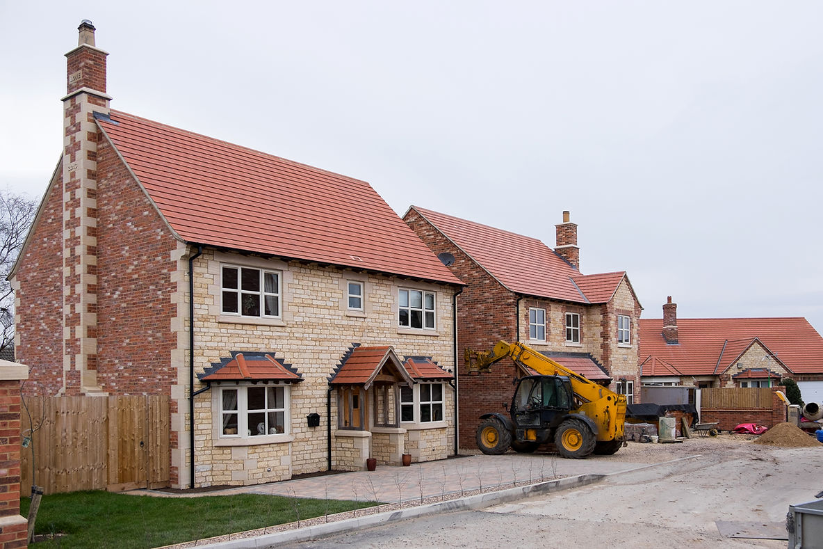 row of houses and excavator