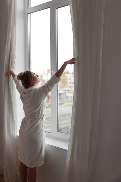 Woman Opening Curtains