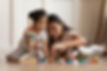 Asian mom helping her kid building blocks