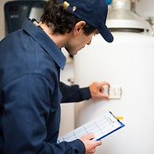Plumber Inspecting Boiler