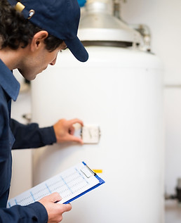Plumber Inspecting Boiler