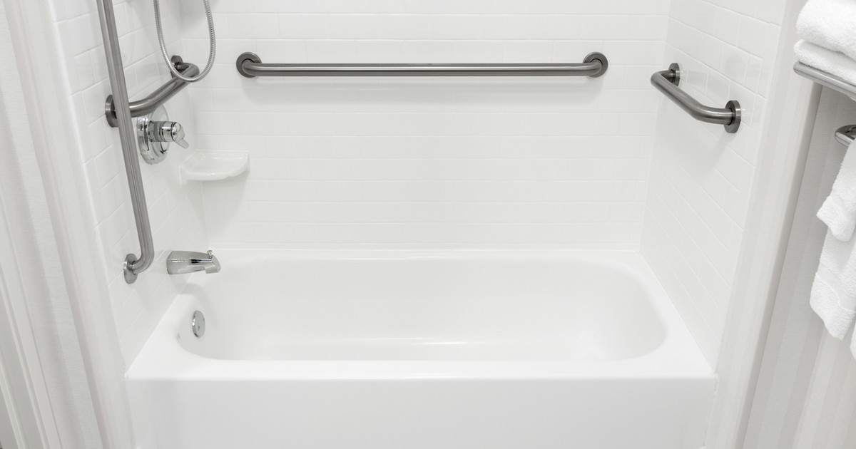 A person using simple assistive equipment in the kitchen and bathroom to complete everyday tasks safely and independently while living with persistent pain.