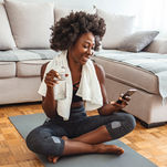 Woman, working out, on phone accessing Forma Wellness