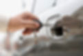 Close up of man's hand unlocking car door with key