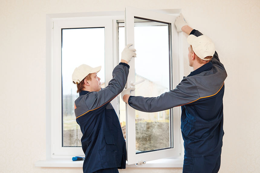 two windows installation workers installing double-glass pane