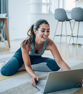 Woman smiling during an online fitness coaching session via laptop with Get Fit With Frank