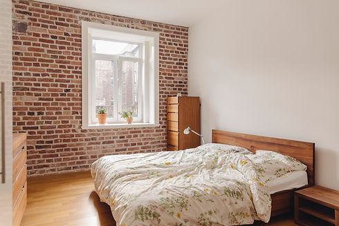 Bedroom in modern building with brick wall