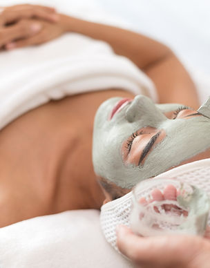 A woman getting facial masked