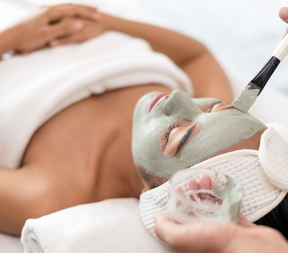 A woman getting facial masked