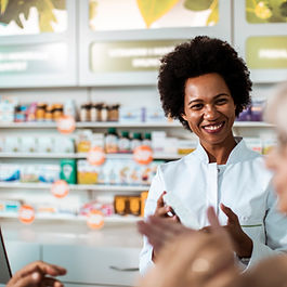 Couple speaking to pharmacist