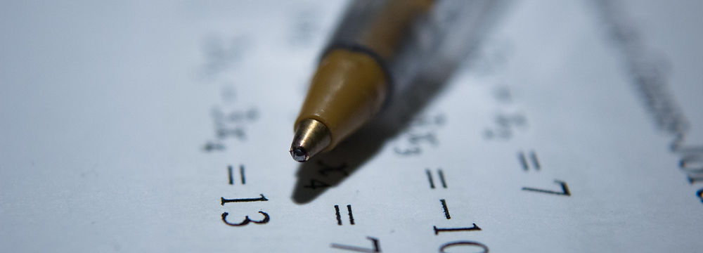 pen over math equations on paper