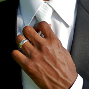 man adjusting a tie