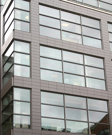 Modern office building exterior with large glass panels.