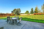 Patio area overlooking backyard landscape