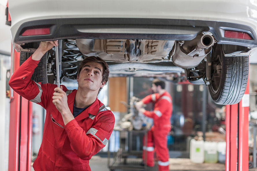 Car mechanic at work in repair garage