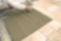 Tile Setter Troweling Mortar on a Master Bathroom Floor