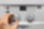 Professional adjusting a house heating boiler for optimal performance and comfort.