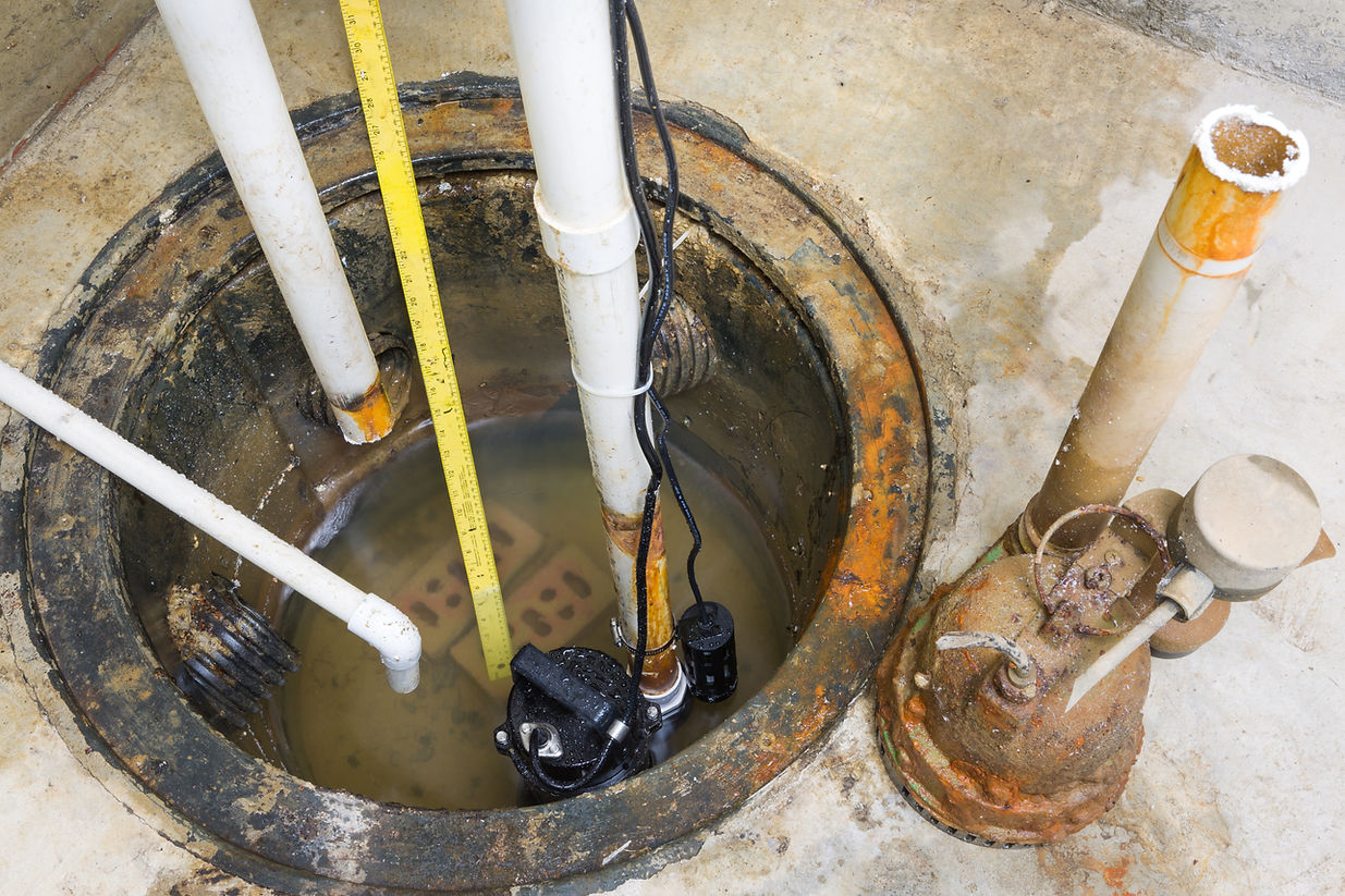 Top down view of a concrete manhole and drainage pipe system