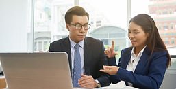 Asian female office worker explaining to her boss