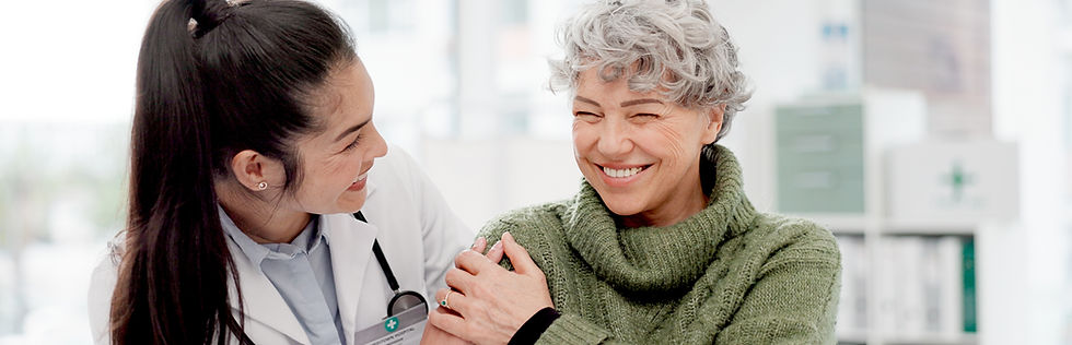 Female doctor supporting a smiling senior woman.