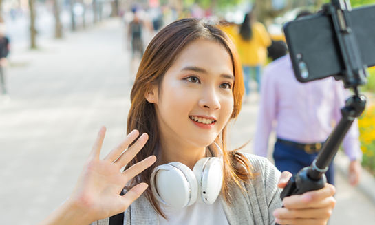 Asian vlogger filming herself on the street