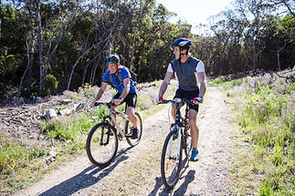 Father and son cycling in nature together