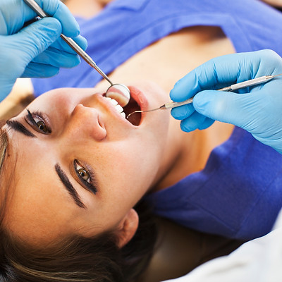Dentist examining patient's teeth