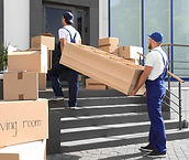 Professional movers carrying furniture for a local move