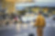 Rear View Of An Adult Man With Luggage Standing On Street At An Airport
