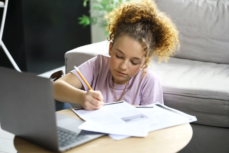 Child receiving personalised Spanish homework support with guidance from a language teacher