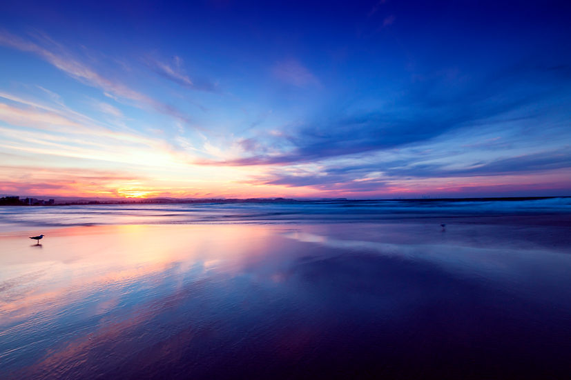 Vibrant and colorful sunrise over water and ocean