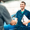 Customer handshakes car mechanic after leaving the car for repair