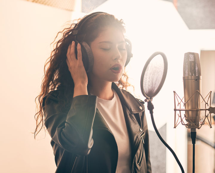 woman singing in recording studio