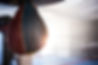 Close-up of hanging leather punching bag at fitness studio