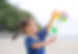 Smiling Asian girl playing pinwheel