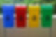Four colorful recycling bins are lined up