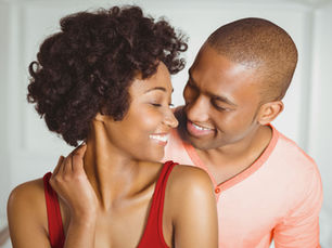 Couple smiling after an online couples therapy session