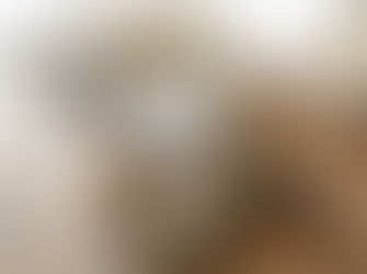 Stack of Earth-tone bar soaps on wooden table