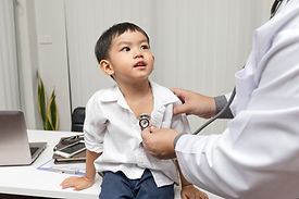 A doctor examining a boy
