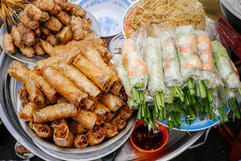 Dishes of Vietnamese grilled pork sausage and spring rolls