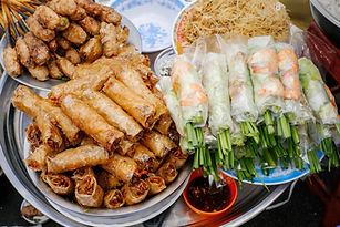 Dishes of Vietnamese grilled pork sausage and spring rolls