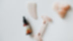 Close-up view of a gua sha tool resting on a smooth wooden surface