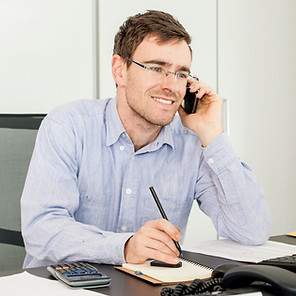 Happy employee answering the phone in office