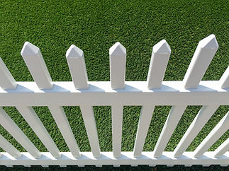White picket fence with pointed tops