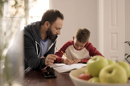Father helping son doing homework