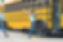 Girl with raised arms in front of bus